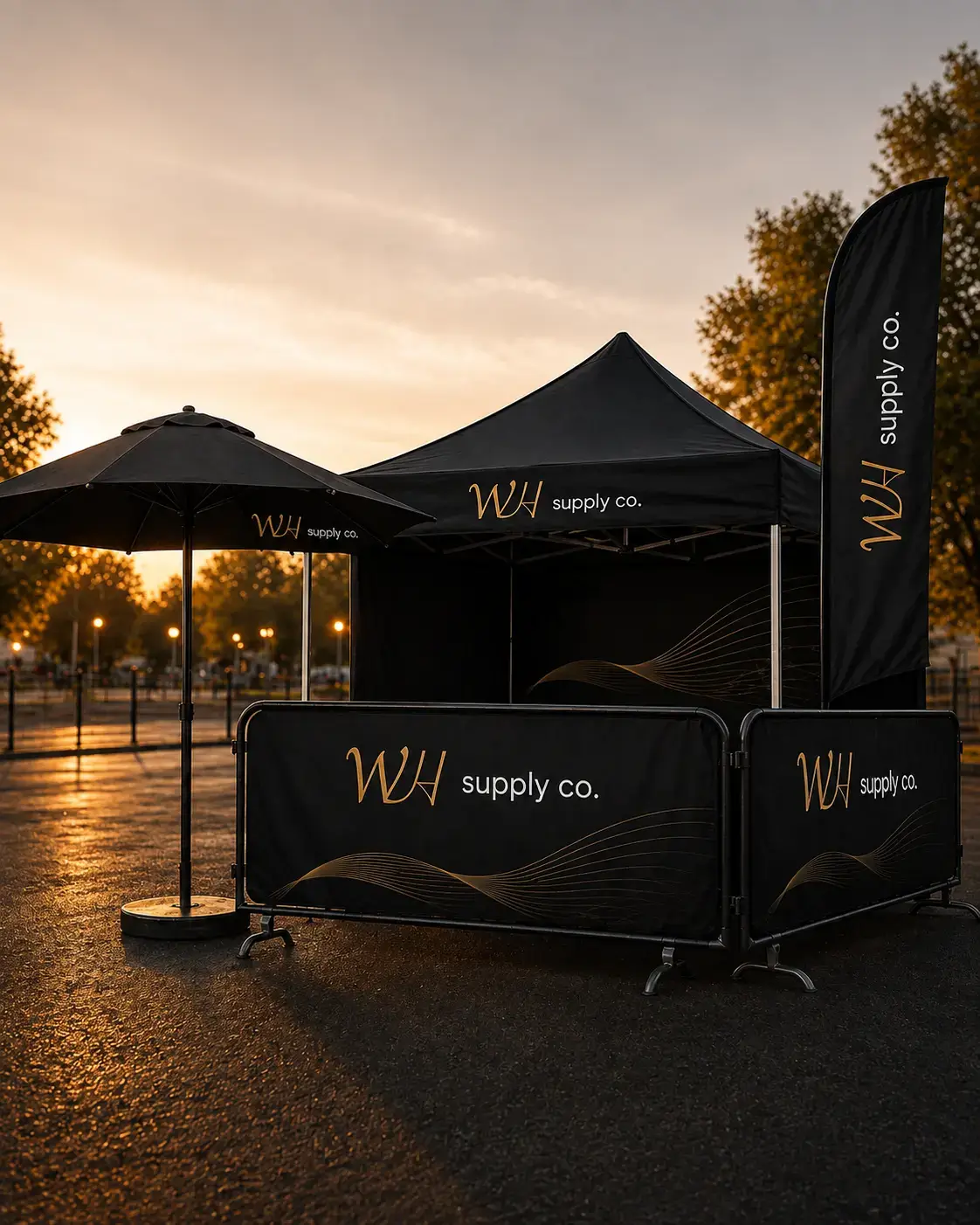 Branded outdoor event setup with custom tent, flags and barrier covers